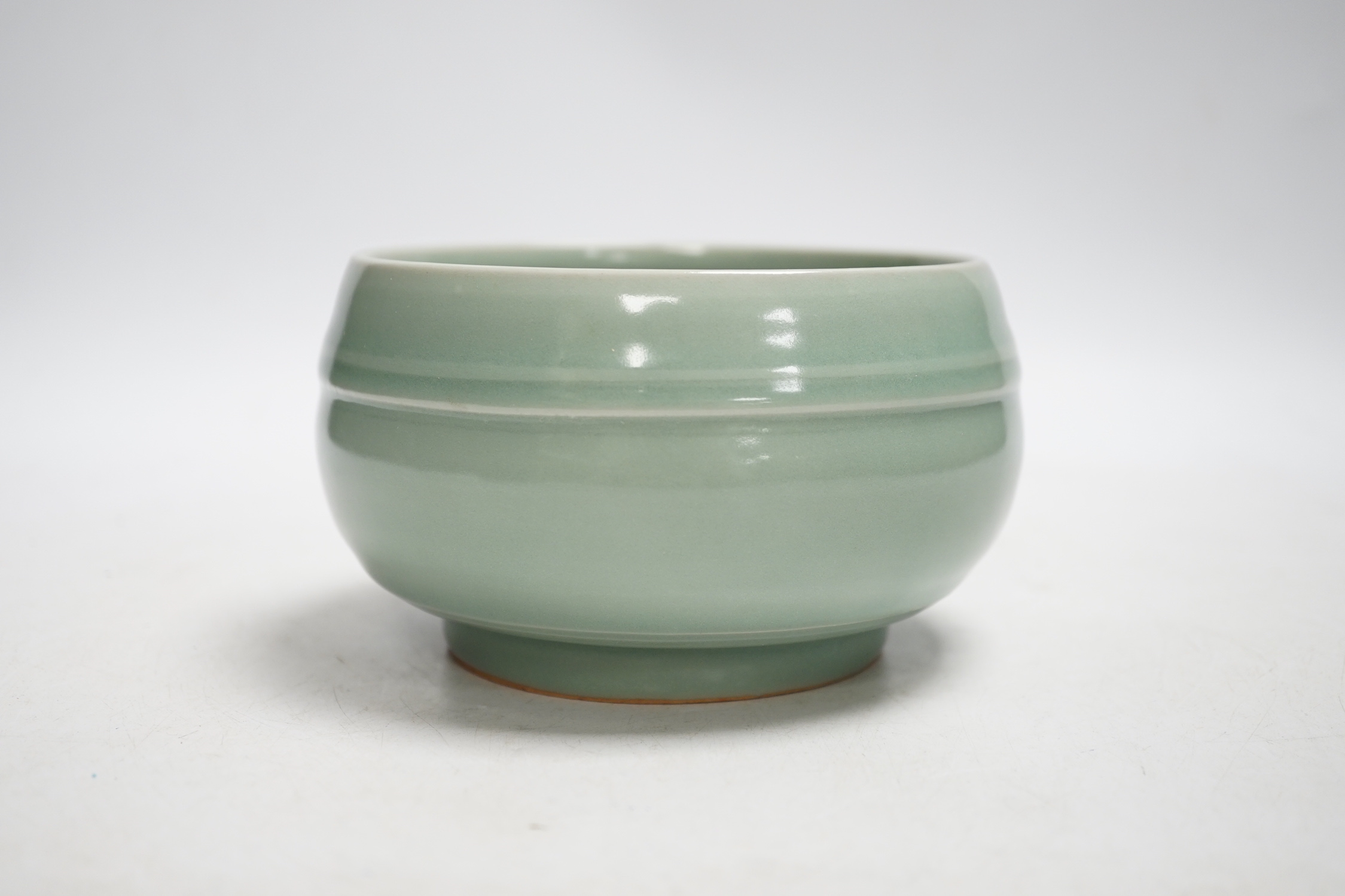 A Chinese celadon glazed pot, 8cm high